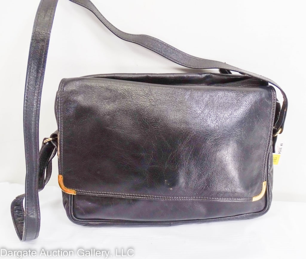 MARIO VALENTINO BLACK LEATHER FOLDING DUFFEL BAG: Black leather duffel bag that folds into a purse. Shoulder strap snaps off and on. Gold tone tag in flap pocket "Mario Valentino Made in Italy"/ Measures: Folded: 8"H x 11"W, Unfolded: 13"H x 24"W