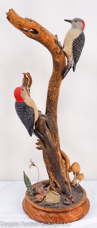 TOM SZVECH HAND CARVED RED BELLIED WOODPECKERS: Circa 1985, this is avery well done wood carving of two red bellied wood peckers carved by tom Szuech, dated 1985. These are posed on a tree branch with mushrooms and a metal flower and leaves on base
