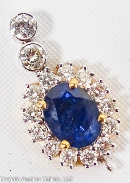 18K GOLD DIAMOND & BLUE TOPAZ PENDANT: Dual tone gold - base is yellow gold with stones set in white gold / 15 diamonds: (2) 2.26mm, (13) 1.7mm estimated 0.34cttw / Topaz: 5.9mm x 7.9mm estimated 1.6ct / Weight: 2.7g / Measurements: 0.75"H