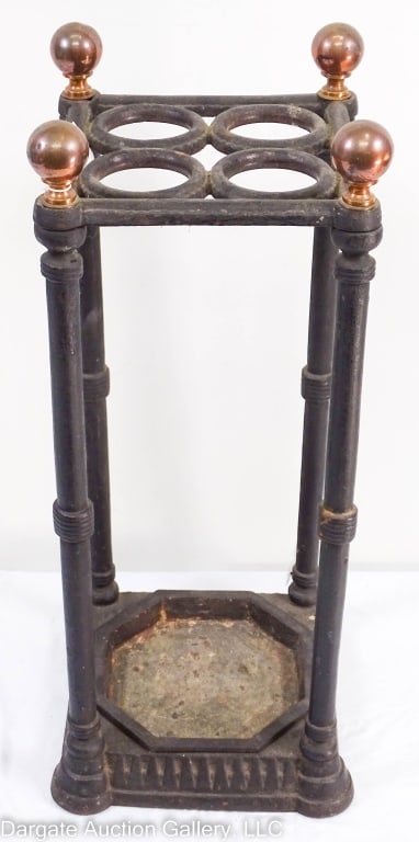 LATE VICTORIAN CAST IRON UMBRELLA STAND: Eastlake Victorian cast iron hall Umbrella/Cane holder. Old black, possibly original paint with some scuffing and wear, and minor rust on underside. Retains the original octogon shaped cast iron drip 