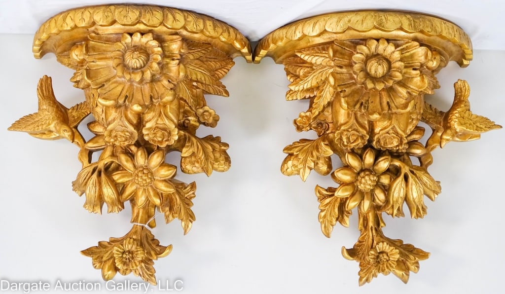PAIR CARVED GILT WOOD WALL SHELVES: A pair of gilt painted carved wooden half round wall shelves featuring birds with flowers and leaves, metal brackets on back for hanging. / Measures: 13.5" x 6.25" x 12" / Provenance: From the descend