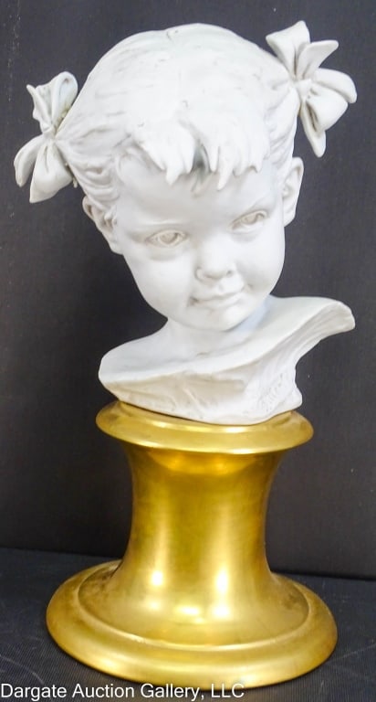 BRUNO MERLI PORCELAIN BUST OF A YOUNG GIRL: Bruno Merli (Italian, 20th Century) Porcelain sculpture "Bust of a Young Girl" on a gold painted plinth. Marked on base [Porcelain - Works of art] / Measures: 12.75"H x 6"W x 5"D / Provenance: From th