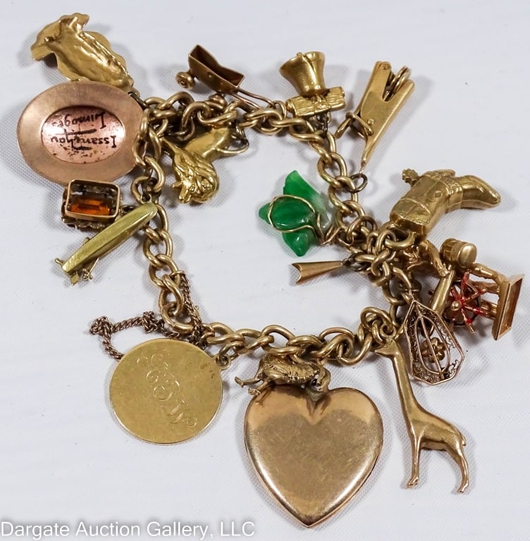 14k & 10k GOLD CHARM BRACELET: Charms include: heart locket, Limoges portrait, stamp, Liberty Bell, animals and others. Marked or tested 10k & 14k / Weight: 69.4g combined total weight / Measurements: approx. 6" long/ ONLINE PAY MS