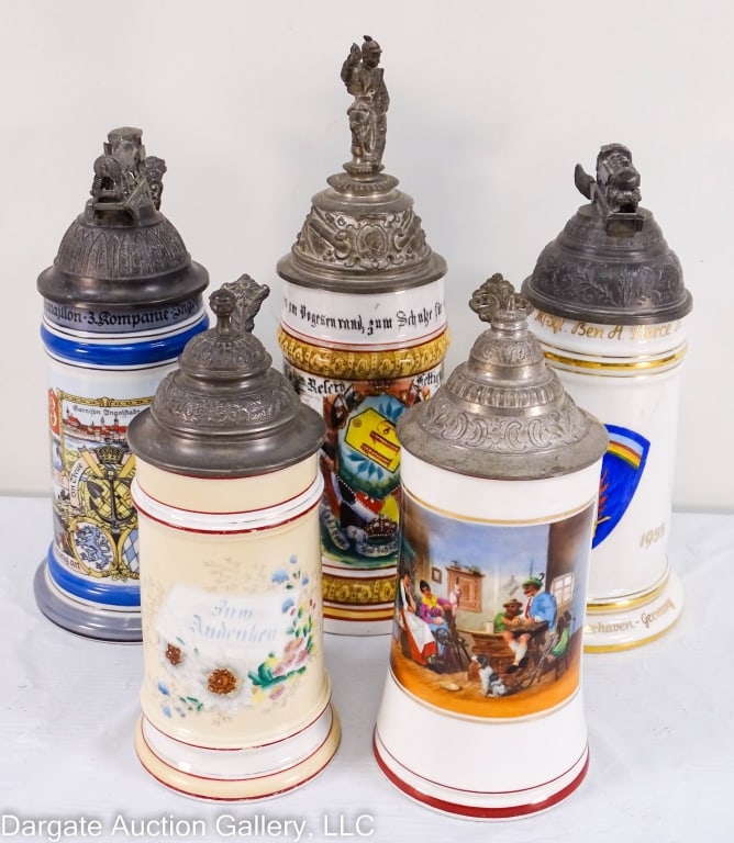 5 GERMAN LITHOPHANE BEER STEINS W/PEWTER LIDS: Five German beer steins all with lithopane bottoms and pewter lids. Two have steam engine finials, one has a finial of a soldier. Largest is 11" x 4", smallest is 8" x 3.5".