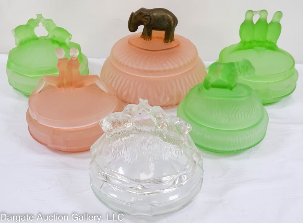 6 ASSORTED GLASS VANITY POWDER JARS: 1920s to 1950s glass powder jars: Elephants, bulldog, nudes and birds. Pink and green satin glass, one crystal marked L.E. Smith-Tiffin-others. Includes Depression glass. Jars range in size from 4.25"