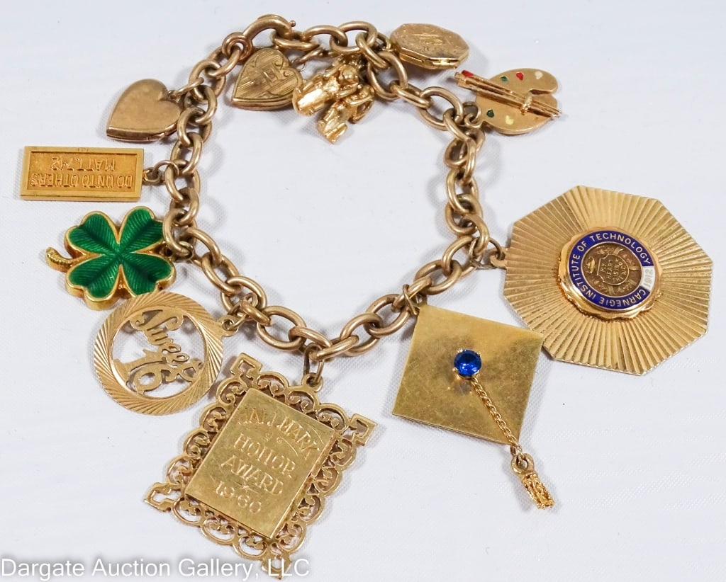 14k & 10k GOLD CHARM BRACELET: Includes several lockets, a Carnegie Institute of Technology, graduation cap, enameled 4-leaf clover and others / Charms are all marked or tested 10k and 14k / Weight: 45.4g total weight / Measurement