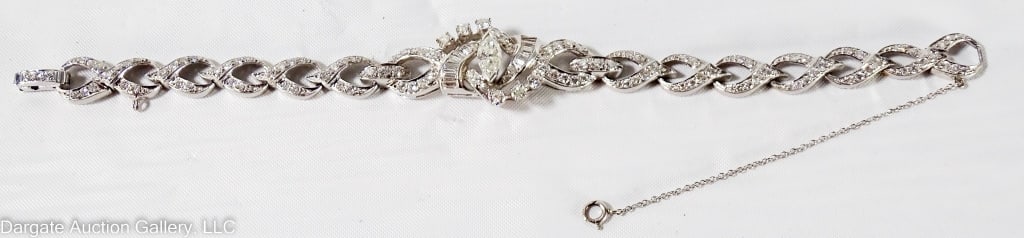 PLATINUM AND DIAMOND BRACELET: .5 ct Marquis cut center diamond, flanked by baguettes and 6 round cut / 2.375 cttw / with safety chain / marked PLAT 900 IRID 100 / Weight: 21g / Measurements: 6.5" long / 2.375 cttw/ ONLINE PAY MSG