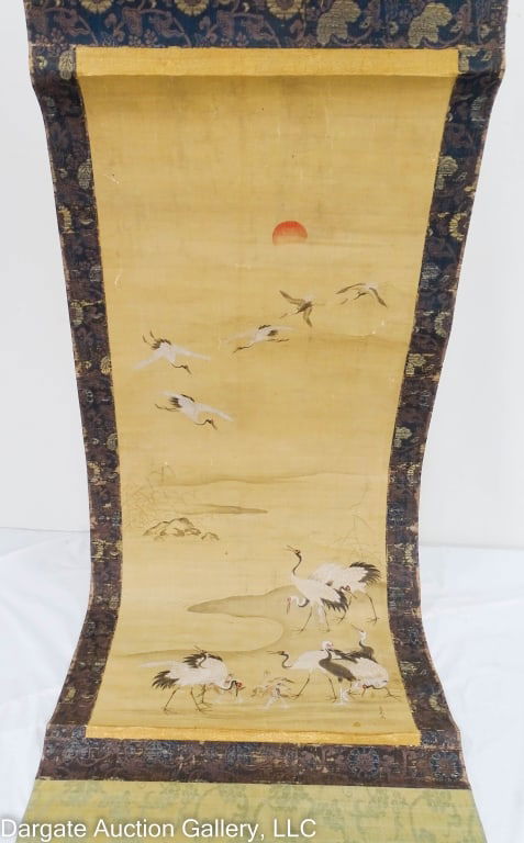 17/18th CENTURY EDO PERIOD JAPANESE CRANE SCROLL: Features cranes at the water's edge, and flying in the sky with bamboo on the shore, all under the setting sun; signed and sealed lower right (Seal is barely visible) / Visible Art Size: 40"H x 16"W /