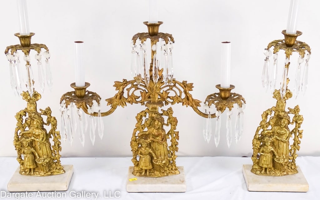 3 PCS VICTORIAN BRASS GIRANDOLE WIRED AS LAMPS: This set consists of two single light candlesticks(20" x 6" x 4"), and a 3 light candelabra(20" x 18" x 4"). Figural brass of a mother and child, complete with prisms on marble bases. All three have b