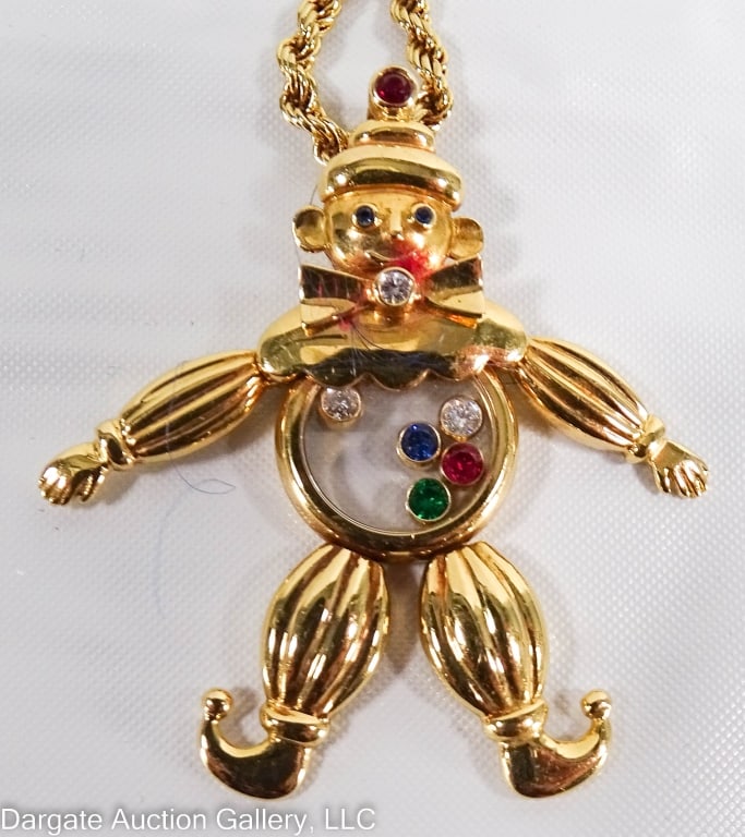 18K CHOPARD HAPPY DIAMONDS CLOWN NECKLACE: 18k yellow gold Chopard necklace, articulated clown with a clear mid-section / Includes 3 diamonds, 2 rubies, 1 sapphire & 1 emerald. 14.6g total, 23" rope chain 17.1g // Both Chain & pendant are mark