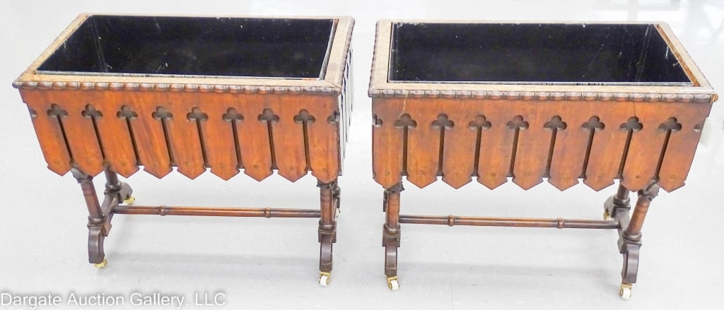 PAIR CHERRYWOOD PLANTERS ON TURNED LEG BASE: Pair Victorian planters on turned leg base. The planter boxes are dovetailed with a cutout clover design on the sides. Metal insert liners. Brass & porcelain casters are replacements. / Measures: 22.5