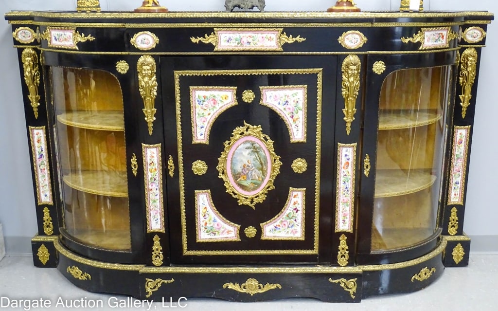 19TH CENTURY FRENCH CREDENZA: Ormolu mounts and handpainted. Dresden panels, center scenes depicting a courting couple. Ebonized finish with gilt bronze mounts and pink floral dresden panels. Mirrored top. Two curved glass outer d
