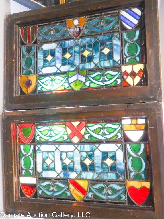 ENGLISH TUDOR STYLE STAINGLASS WINDOW: Nice pair stain glass windows, English Tudor style. 6 shields around the edges, shades of blues, greens, amber, white, reds. Heavy original frames. Frame size 16" x 24" X 1.75" thick. Glass size 20" x