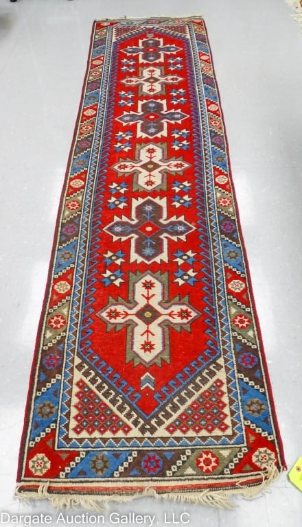 TURKISH ANATOLIAN RUNNER: Blue/cream/burgundy. Illegible tag. / Measures: 28"W x 109"L / Provenance: From the descendants of Lollie Oliver, Pittsburgh, PA / Condition: Wear to fringe