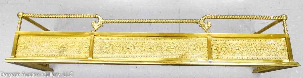 VICTORIAN CAST & STAMPED BRASS FIREPLACE FENDER: Nice Victorian brass fireplace fender with stamped brass panels, cast brass frame & rails. Ram's head supports. / Measures: 9.5"H x 15.5"W x 51"L / Condition: Very good condition.