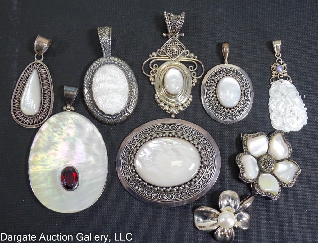 9 ASST STERLING MOTHER OF PEARL PENDANTS: Includes: Suarti Bali Tear Drop shaped [925 BA INDONESIA] / Ann King flower with central pearl [ANN KING 925] / Large oval Mother of pearl with Sterling frame and red rhinestone [925] / (2) Suarti Bal