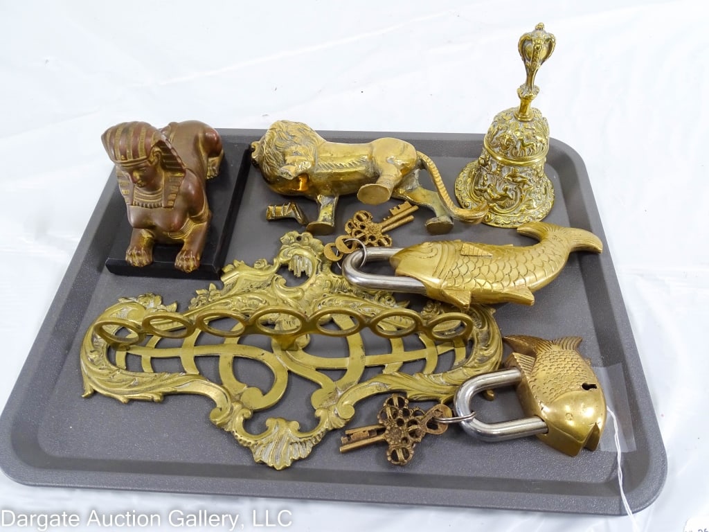 BRONZE SPHINX ASSORTED BRASS LOCKS, LION, BELL: Bronze Sphinx on black marble base, assorted brass items including 2 fish padlocks with keys, wall pipe rack, lion and bell. Sizes range from Sphinx 5.25" x 3" x 4.5"; pipe rack 10" X 6.5" X 2"; lion 