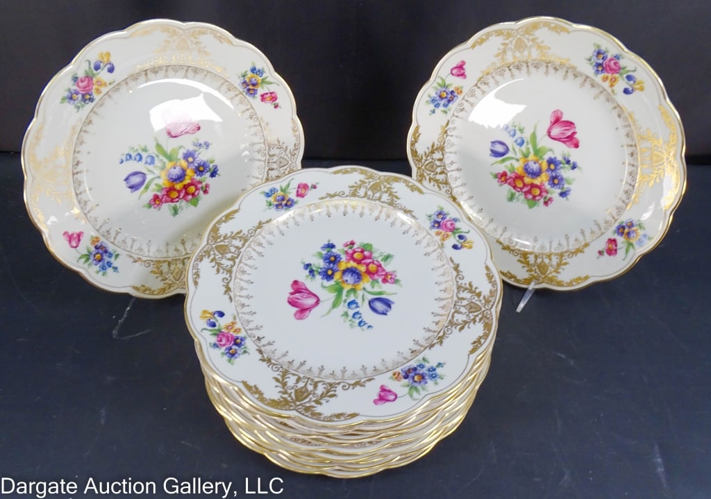 SET OF 12 ROYAL BAYREUTH 11" PLATES: Set of 12 Royal Bayreuth plates. Gold floral design on a cream background. Marked [Royal Bayreuth Bavaria]. / Measures: 11" D / Provenance: From the descendants of Lollie Oliver, Pittsburgh, PA / Cond