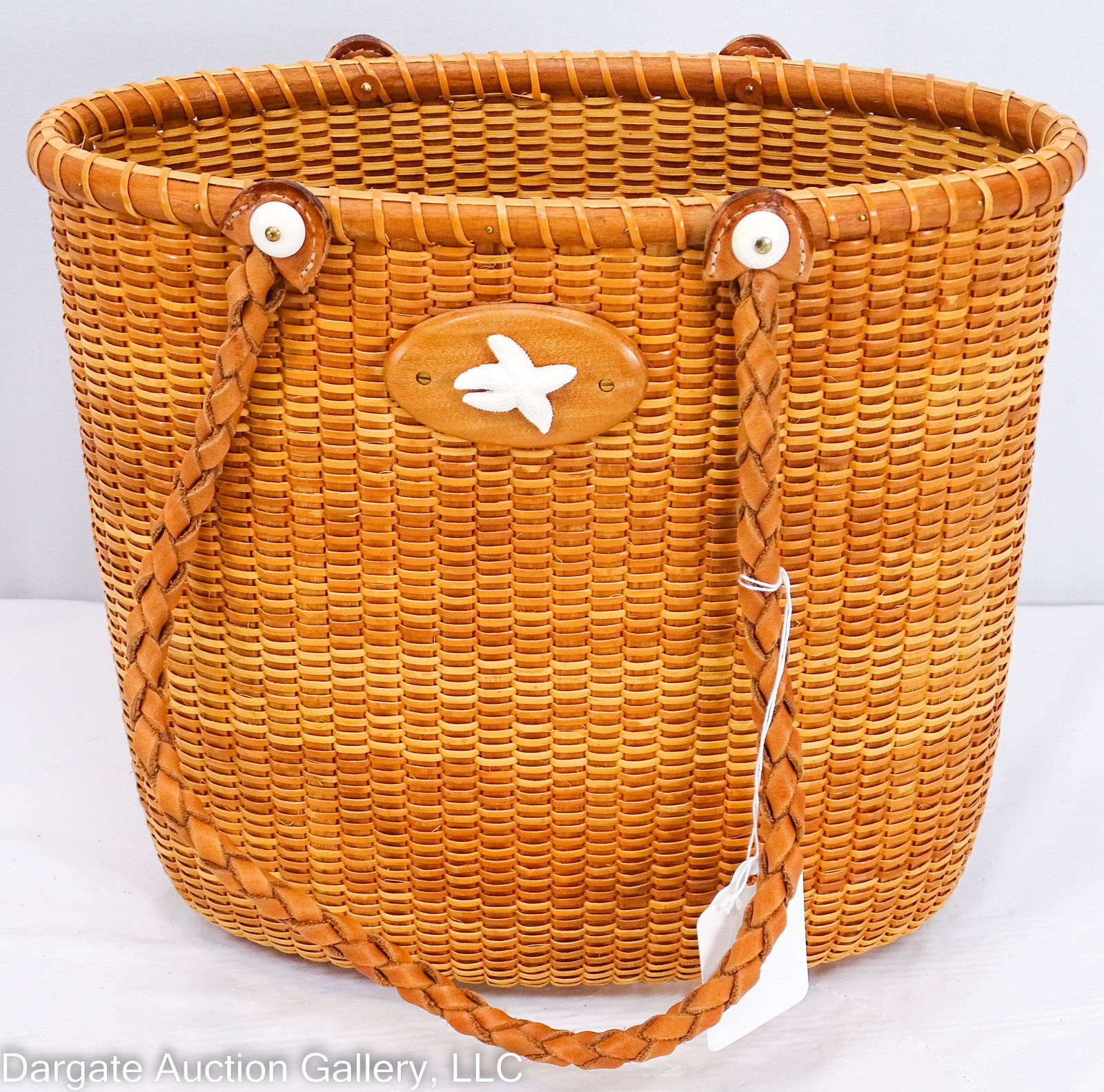 BOBBI HALL NANTUCKET BASKET TOTE: Oval Nantucket basket tote with braided leather handles, a starfish scrimshaw, curly maple base signed "Roberts Fisher Hall Scituate MA" / Measurements: 10"H x 11"W x 5.5"D / Provenance: From the desc