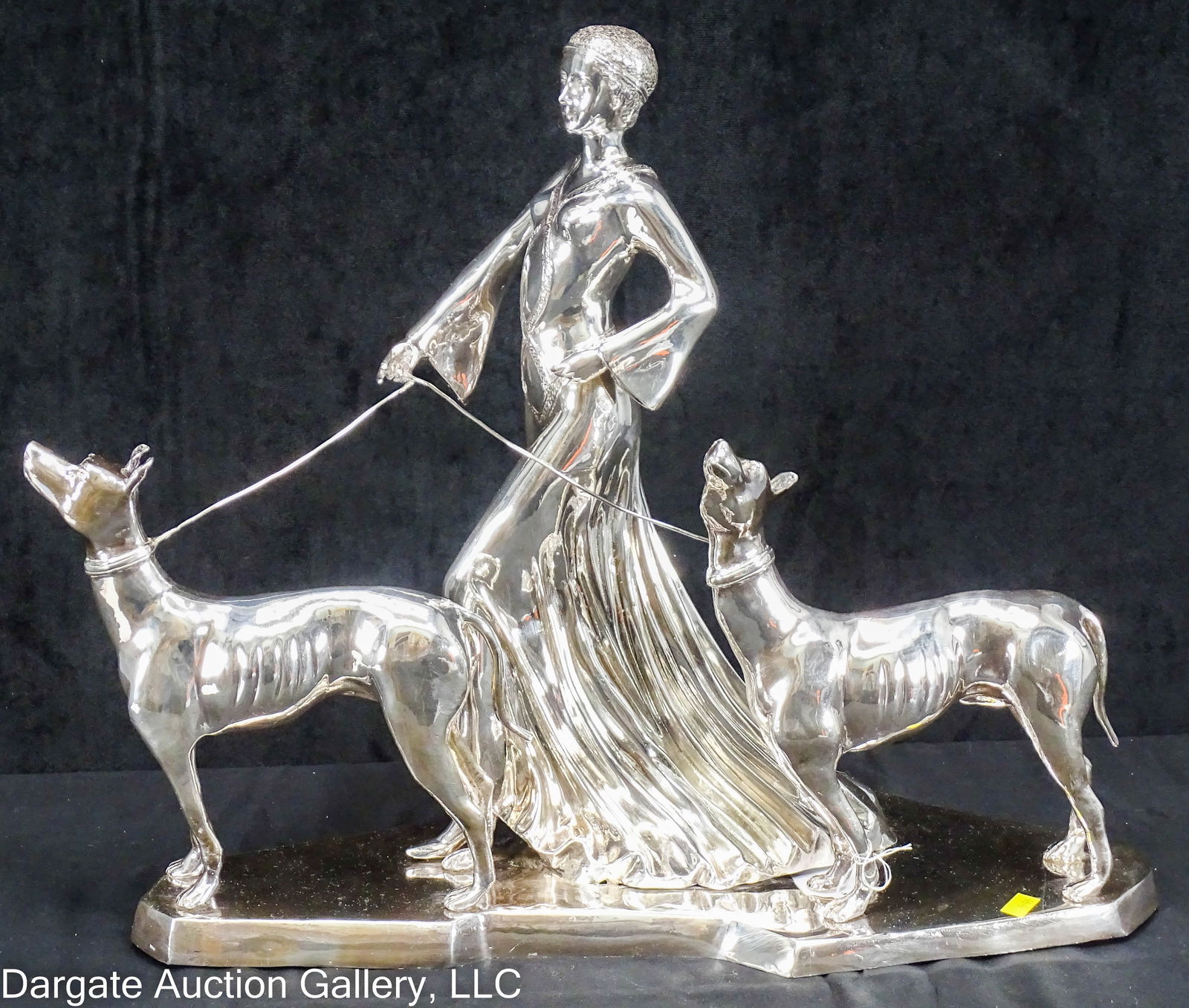 STERLING ERTE STYLE LADY w/ GREYHOUNDS SCULPTURE: A large Sterling Silver sculpture, in the style of Erte (Romain de Tirtoff) of a lady in a long, flowing dress, walking 2 greyhounds; marked [Sterling] and tested as Sterling / Weight: 350ozt / 24 lbs