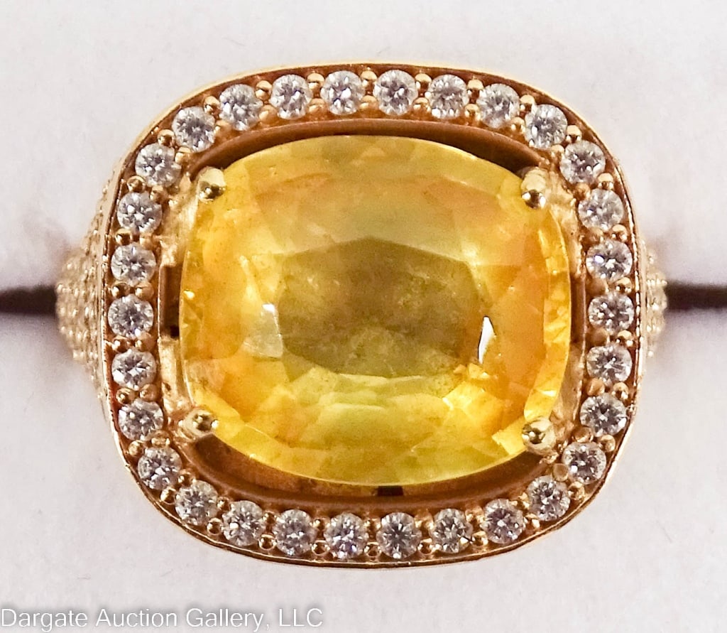 18K OLE LYNGGAARD DIAMOND & YELLOW SAPPHIRE RING: 18k gold ring designed by Charlotte Lynggaard Yellow sapphire (11.78mm x 10.59mm, estimated 6.25ct) surrounded by brilliant cut diamonds. A halo of diamonds surrounds the sapphire, more are set pave s