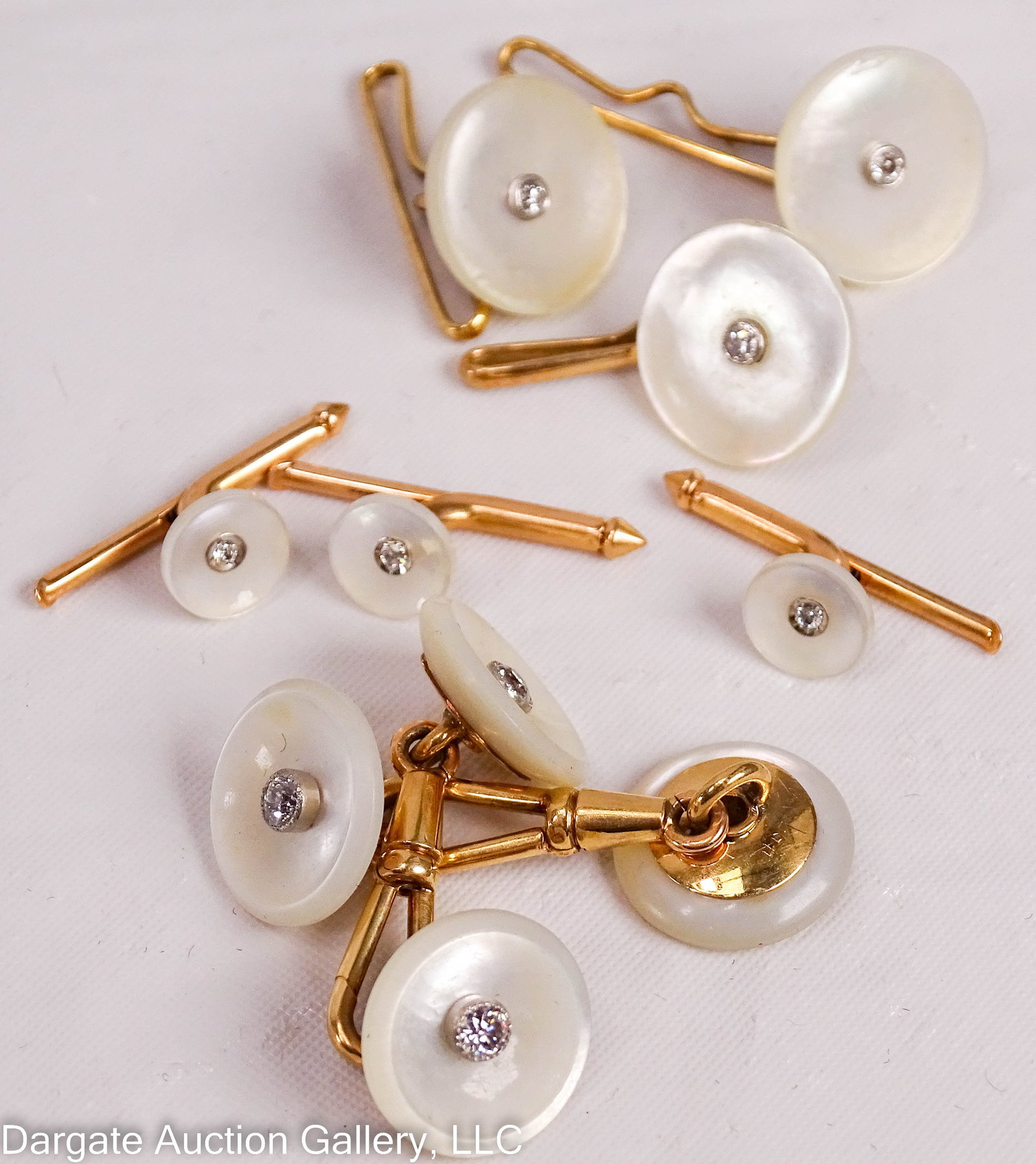 14k YELLOW GOLD MOP AND DIAMOND TUXEDO SET: Set includes a pair of cufflinks (.5” diam), 3 tuxedo studs (.25” diam) and 3 shirt buttons (.5” diam). All are set in 14k yellow gold set with round disks of mother of pearl, and a 