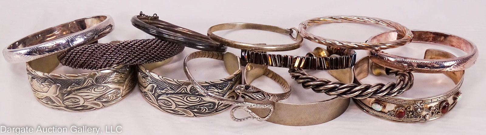 13 ASSORTED STERLING SILVER BRACELETS: Opal & red stone lion cuff bracelet, 3”W, [925]; spring hinge twisted rope bangle, 3”W, [925]; snake bracelet w/stone eyes, 3”W, [925]; (2) engraved bangles, 3”W, [925]; mesh h