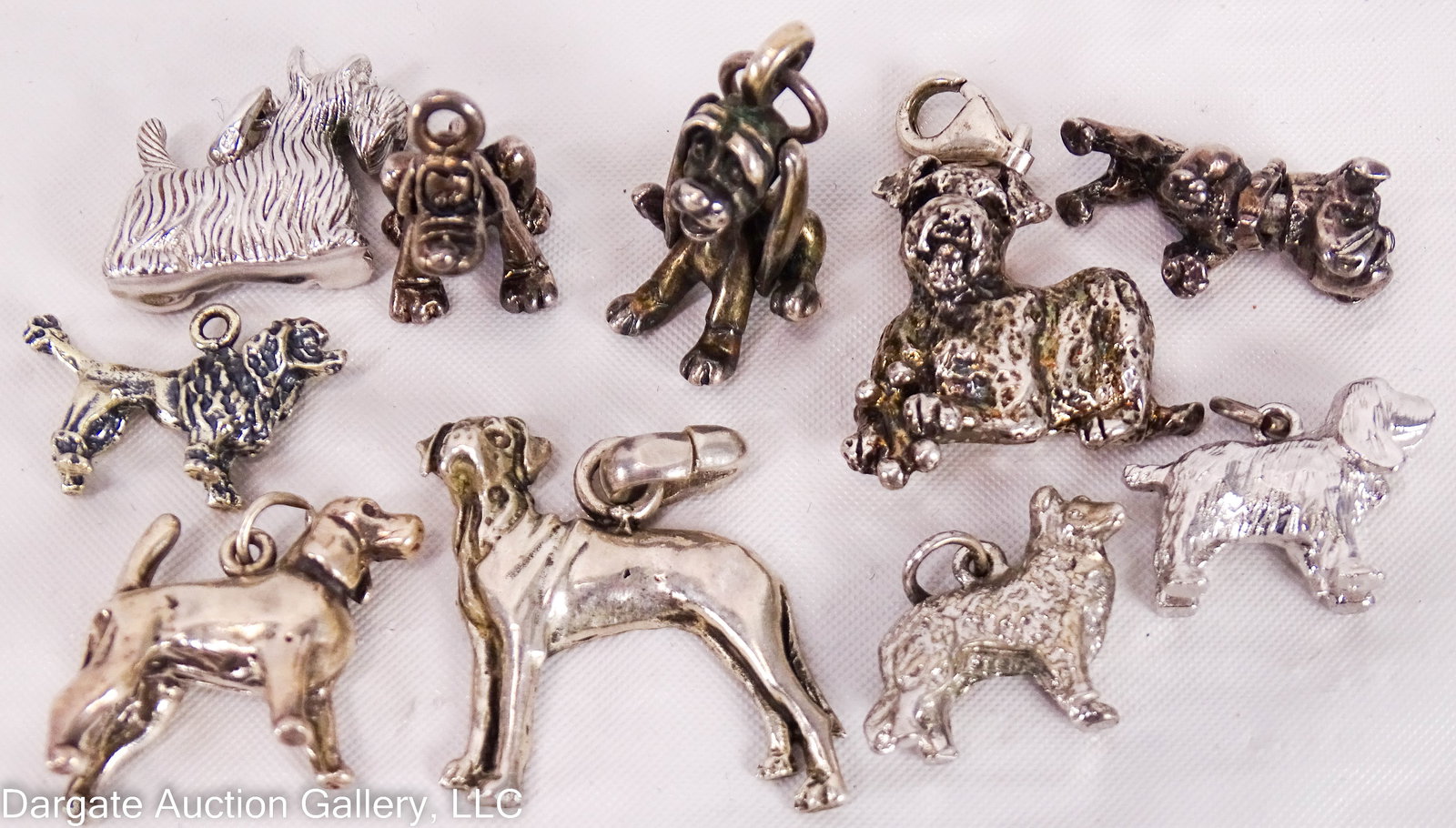 10 ASSORTED DOG CHARMS: Many varieties of dogs, most marked Sterling. Poodle, spaniel & bulldog are not marked, hound dog mark is illegible / Weight: Total Gross Weight: 58.6g / ONLINE PAY MSG ****SEE TERMS AND CONDITION