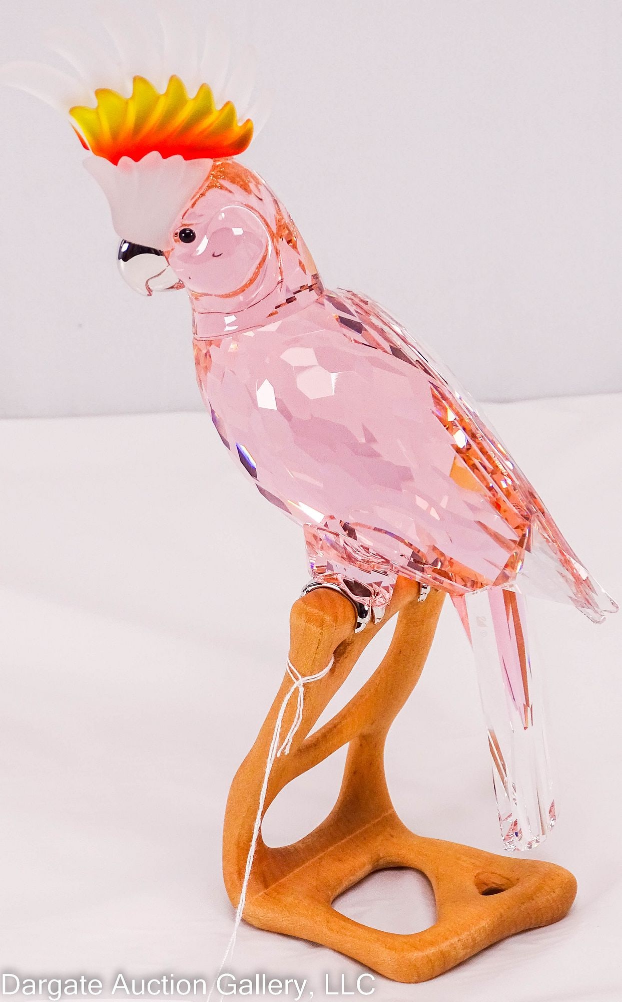 SWAROVSKI CRYSTAL PARADISDE BIRDS COCKATOO RED: 2005 (Retired 2011) A faceted cockatoo in kakadu red crystal, from the Paradise Birds Collection; perched on a wooden base with chrome accents; #718565 / Measures: 9.5"H x 4"W x 4.75"D