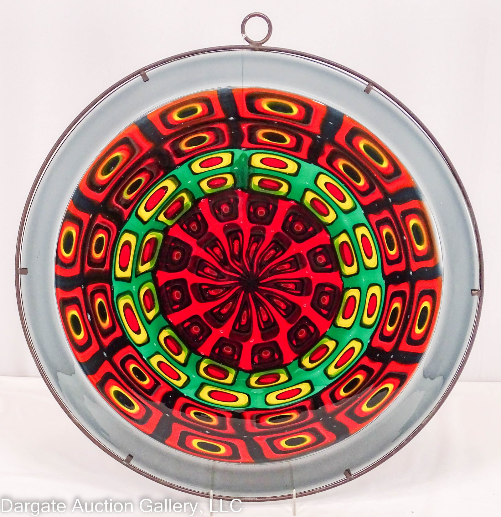 VISTOSI MURRINE GLAS SUN CATCHER: 17.5" diameter Murrine glass disk set in metal frame, with a round hoop at the top to hang in the window. Not signed / Measures: 17.5" diameter