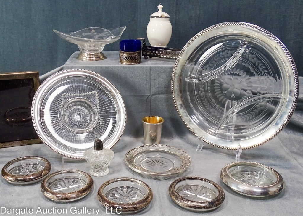 15 ASSORTED STERLING RIBBED TABLE ARTICLES: This includes (2) sterling rimmed glass relish dishes, (5) sterling rimmed glass coasters, (1) sterling rimmed lemon plate, (1) hinged sterling double photo frame, (1) wheel-cut sterling footed glass