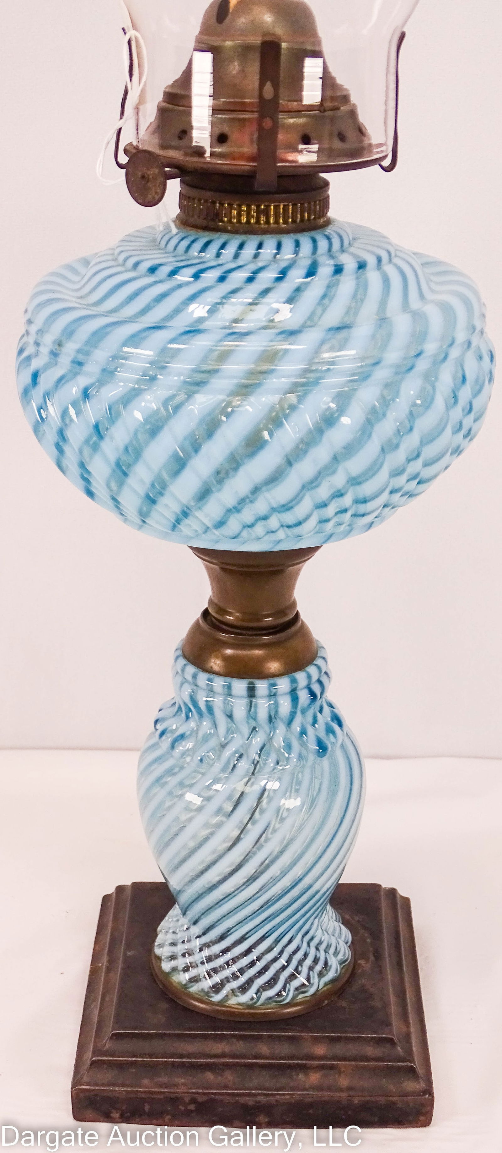SHELDON SWIRL OIL LAMP: Opalescent double composite oil lamp with period beaded top chimney burner, thumbwheel stamped [E. MILLER & CO] Venus burner / Measures: Overall - 20.25"H, Lamp base - 14"H x 5" diameter / Condition: