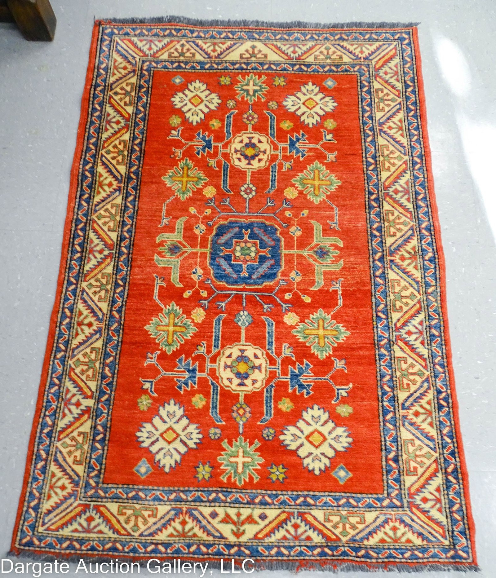 HAND KNOTTED KAZAK RUG 63x42: / Measures: 63"x42" / Condition: Wear to fringe and edge; overall fading