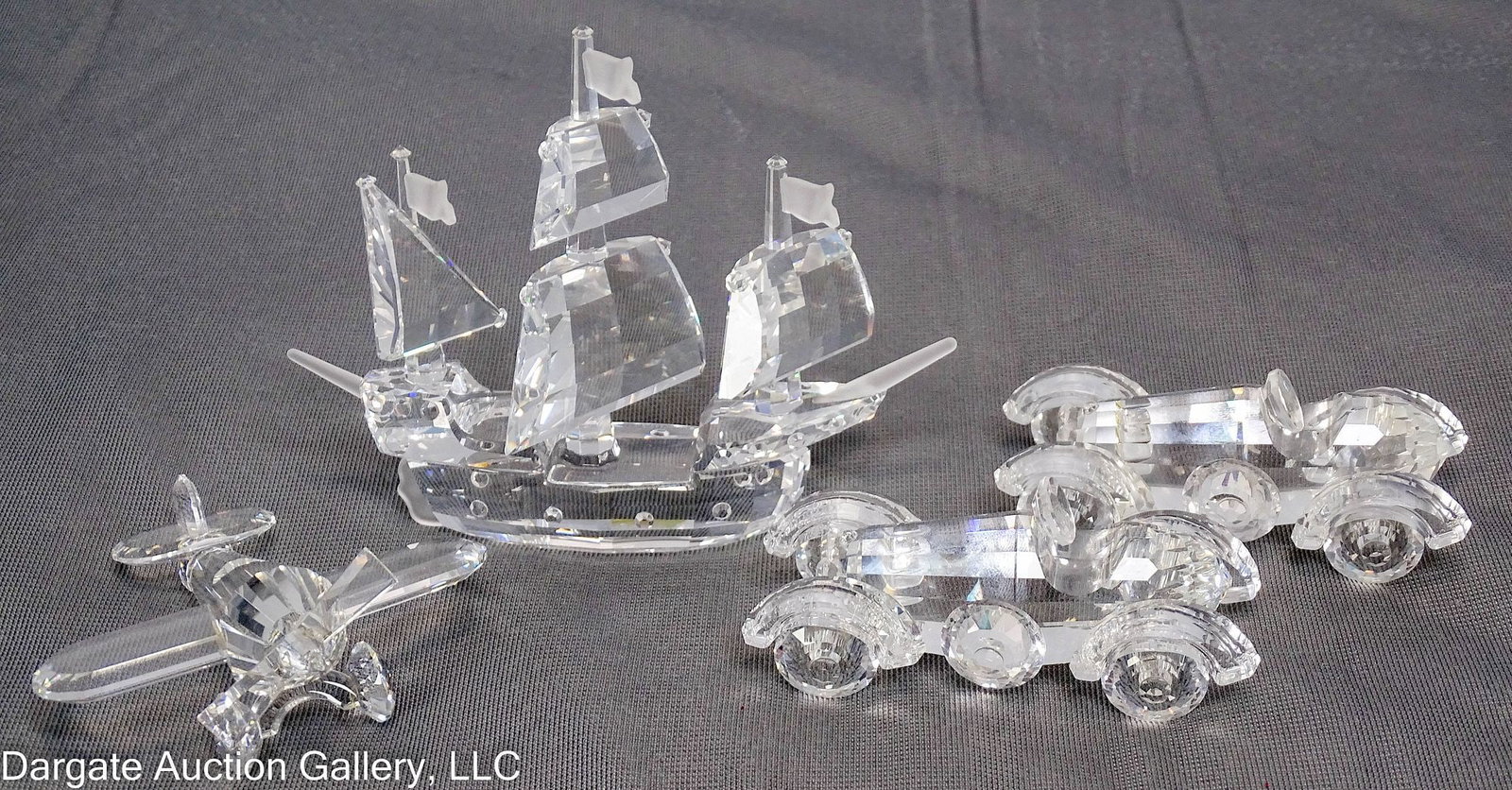 4 ASSORTED SWAROVSKI CRYSTAL VEHICLES: Includes: a satin crystal 3-mast ship (3.5”H x 4.5”W x 1.5”D), a 2-propellor airplane (1.25”H x 3”W x 3”D), and a pair of roaster cars (1.5”H x 3”W x 1.