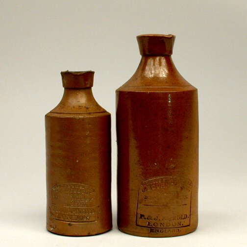 PAIR OF DENBY STONE BOTTLES: Two vitreous stone bottles marked: J. Bourne + Son. Patentees. Denby Pottery Near Derby. P.+ J. Arnold London. 7 1/2"h and 6"h