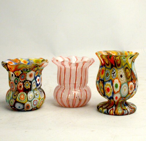 THREE MULTICOLORED TOOTHPICK HOLDERS.: A lot of three multicolored glass toothpick holders. Comprising two millefiori holders and another blown from white and pink canes to look like ribbons or a candy cane