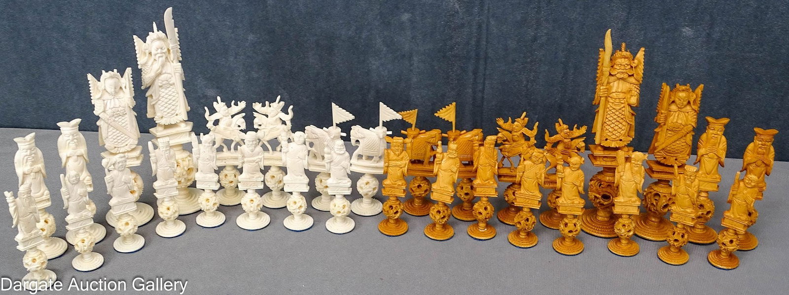 (32) ANTIQUE CHINESE CARVED BONE CHESS PIECES: The dark side pieces are tea stained, light is natural; All pieces stand on carved puzzle balls, circa late 1800's, early 1900's; Measures: King - 6.5"H, Pawn - 3"H; Condition: (1) o