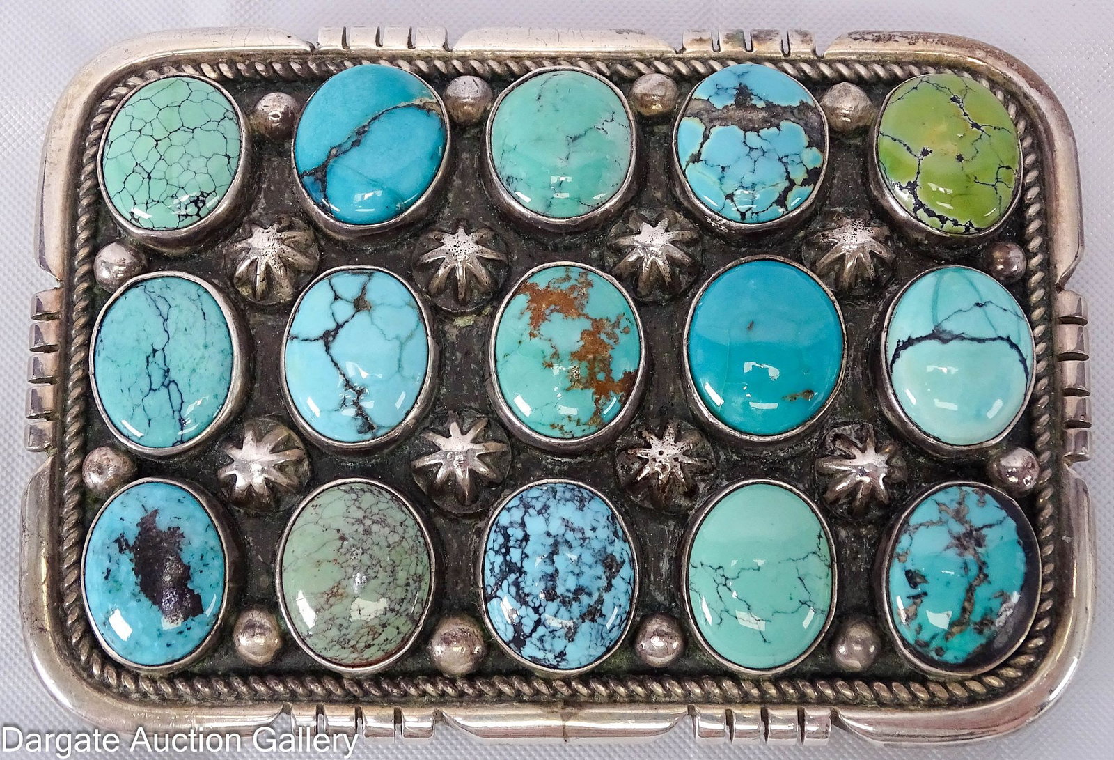 DANNY CLARK NAVAJO STERLING AND TURQUOISE BELT BUCKLE: Rectangular sterling belt buckle inlaid with 15 oval turquoise cabochons; [D CLARK 925]; Measures: 2"H x 2.75"W; Total Gross Weight - 54.6g
