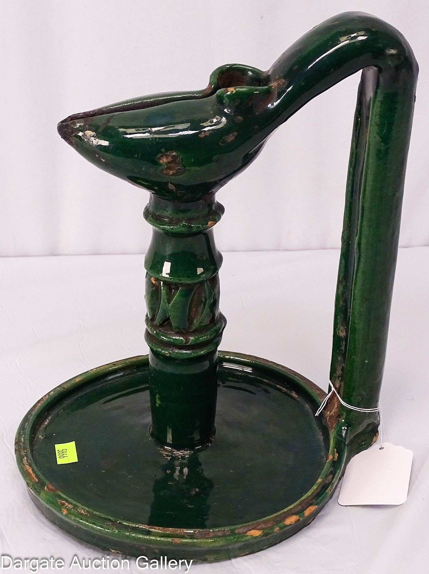 ANTIQUE GREEN GLAZE EARTHENWARE ISLAMIC OIL LAMP: Circa 18/19th Century; Terracotta or Earthenware oil lamp with a thick green lead glaze with Islamic characteristics and probably made in North Africa or the Middle East; The column with incised carve