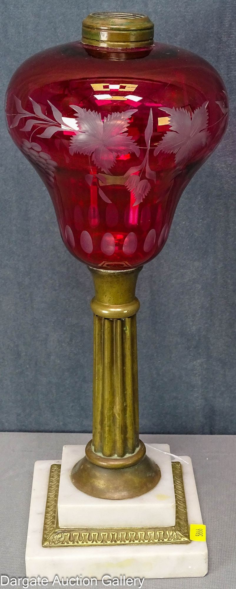 DIETZ MARBLE BASE BANQUET LAMP CRANBERRY FONT: Classic Dietz banquet lamp with stepped Carrera marble and cast brass trim and column; large cut to clear cranberry glass with cuttings of bunches of grapes and a floral motif above a row of cut