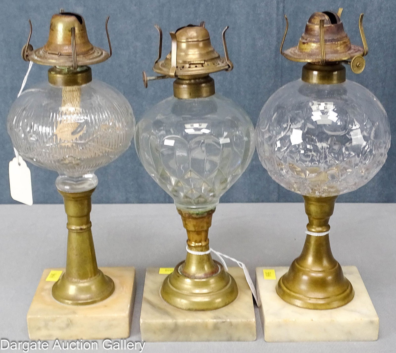 (3) MID 19th CENTURY FLUID WHALE OIL LAMPS: 1860's Marble base lamps with colorless fonts and brass collars; includes: Periwinkle, #1 burner marked [H.B. & H. STAR], 4" diameter font, 9.75"H to collar, 3.5" square b