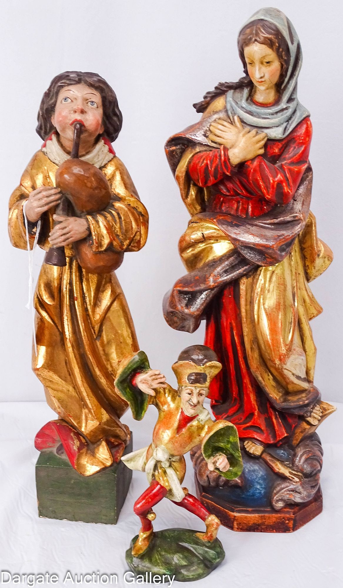 (3) CONTINENTAL POLYCHROME AND GILT CARVED FIGURES: Includes: A 15.25"H painted and gilt depiction of Mary stepping on the Serpents head (Satan). On an octagonal base, with tag marked "Tiroler Heimatwerk Innsbruck" A 13.25"H painted