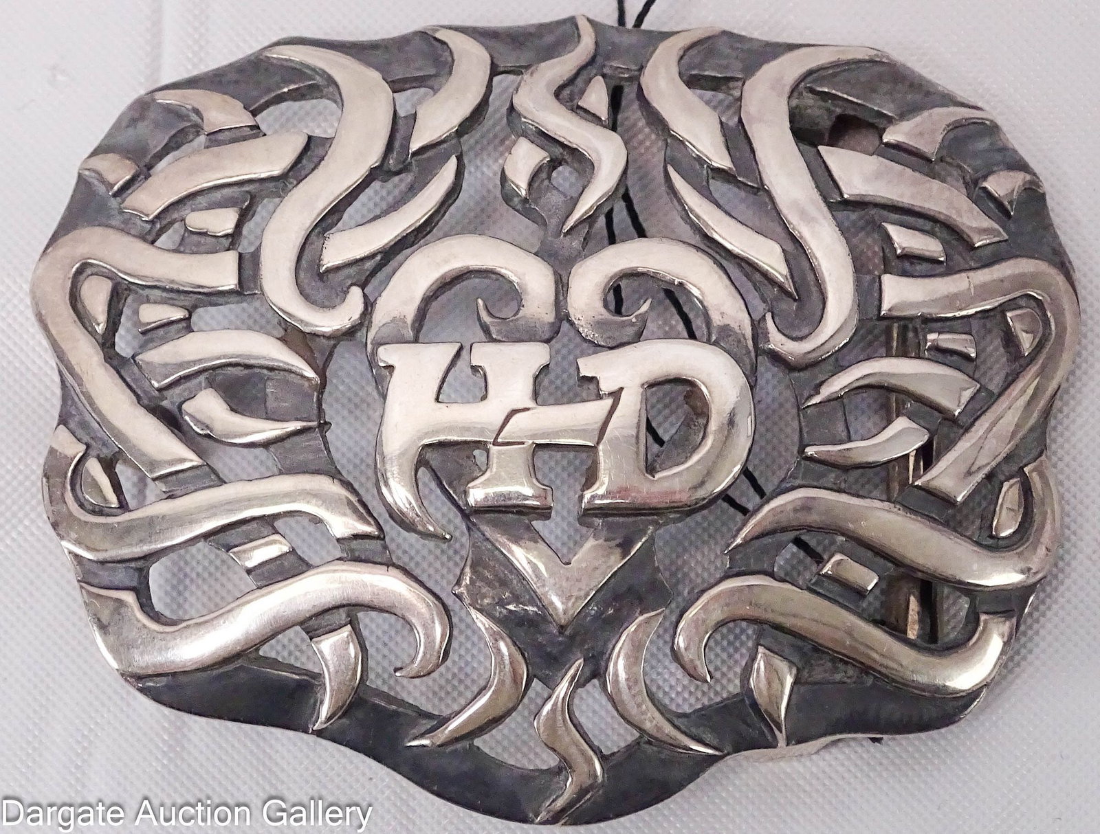 HARLEY DAVIDSON STERLING BELT BUCKLE: Harley Davidson belt buckle with open work design and [HD] in the center, still has original tags [925]; Measures - 1.5"H x 2"W, 27.5g