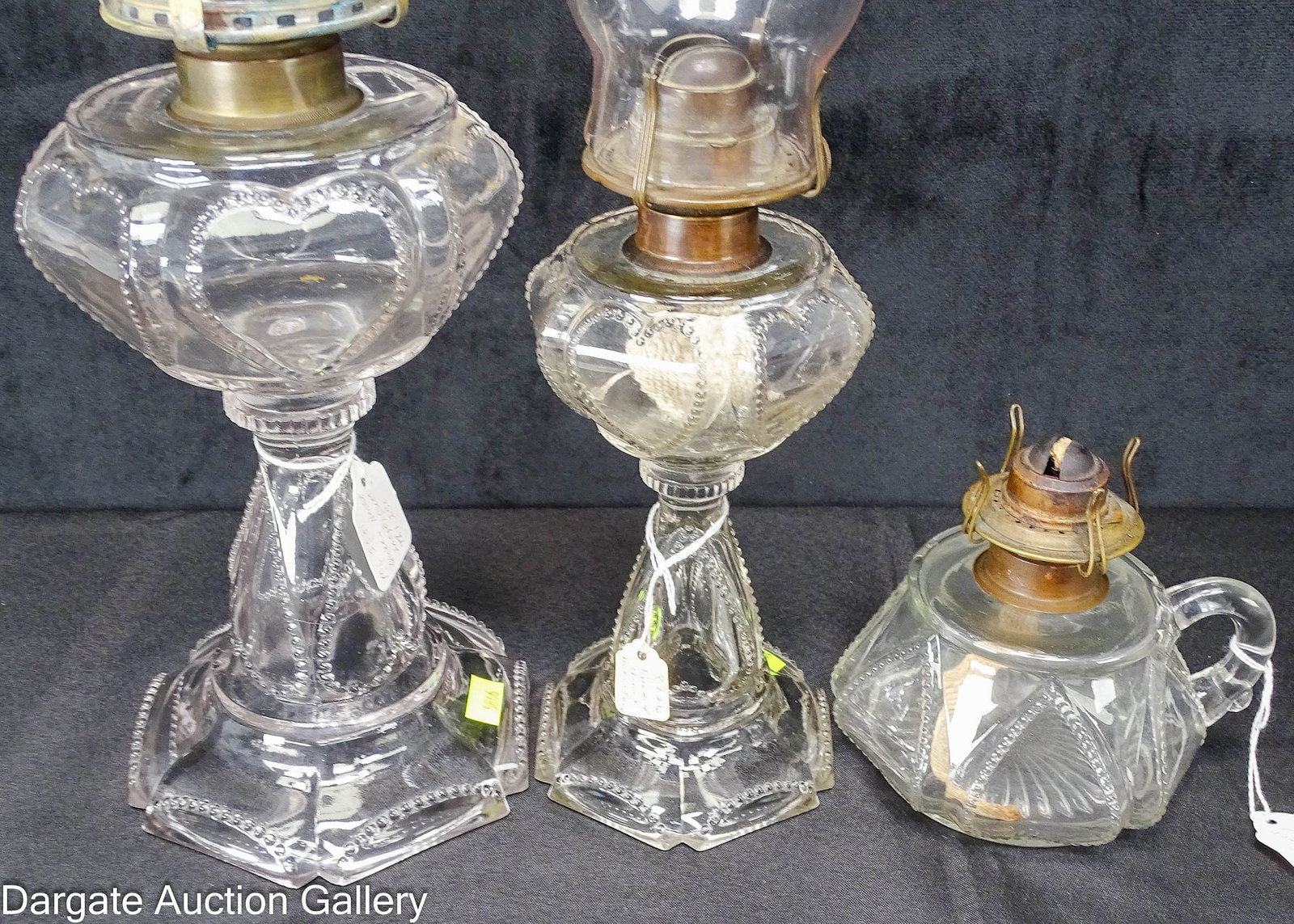 (3) FINDLAY GLASS OIL LAMPS QUEEN HEART: All colorless antique lamps made by Findlay Glass Ohio; Includes: Queen Heart Lamp Stand, #2 brass burner marked [MACBETH] with newer chimney; 10"H to top of collar, 5.75" diameter bas