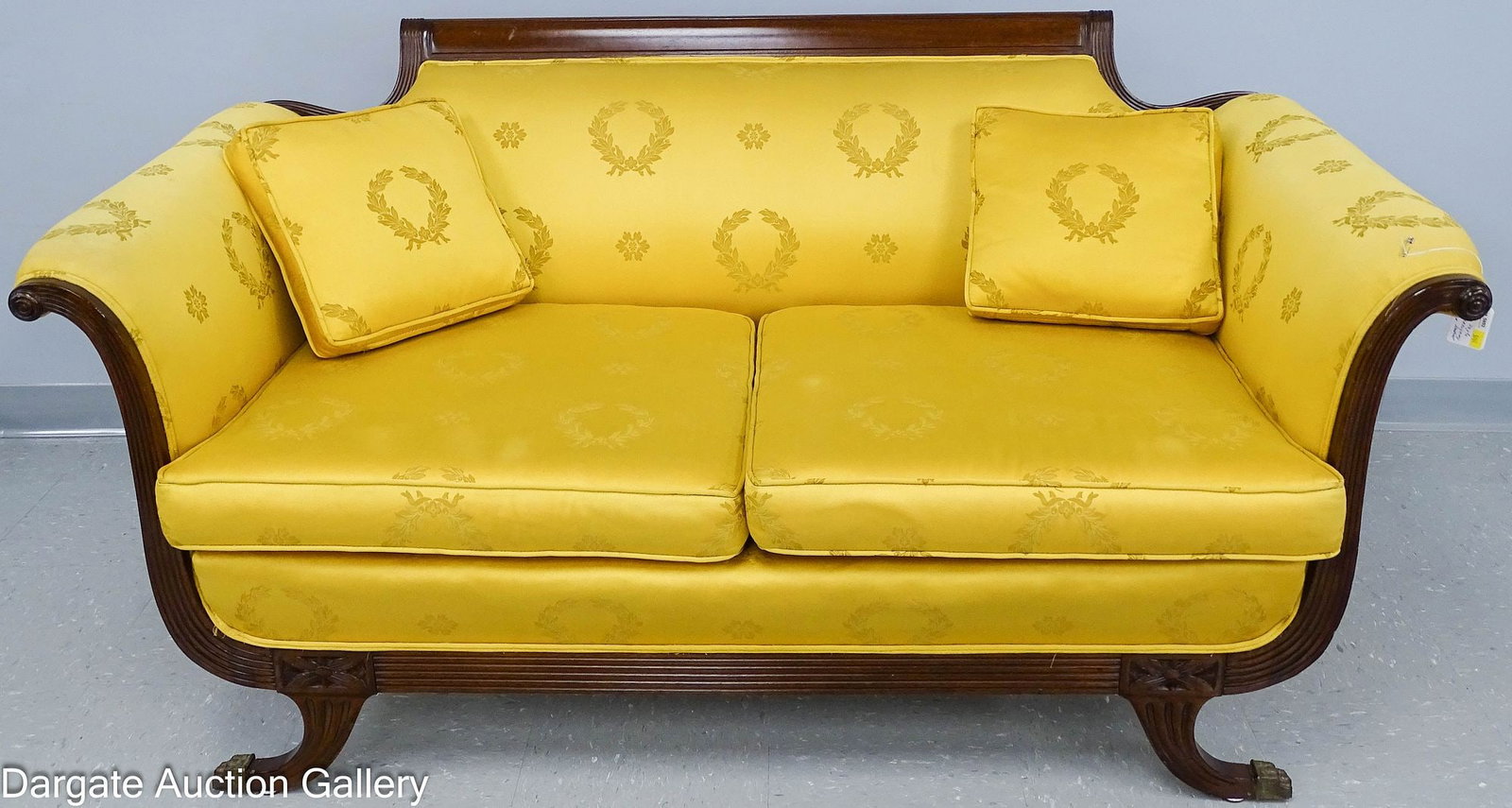 DUNCAN PHYFE EMPIRE STYLE MAHOGANY SETTEE: A Duncan Phyfe Empire style reeded mahogany settee with paw foot brass foot caps, in a gold yellow upholstery; Measures: 30"H x 60"W x 34"D; Condition: Soiling on arms, age appropriate