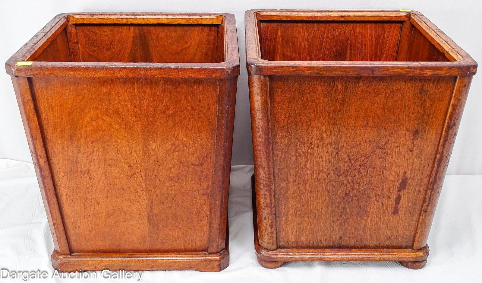 (2) MCM WALNUT WOOD EXECUTIVE WASTEBASKETS: Two mid-century modern executive office wastebaskets made by New Craft Furniture Company, Grand Rapids, Michigan; one unit features bun feet. Please note these are not a matching set. / Dimens