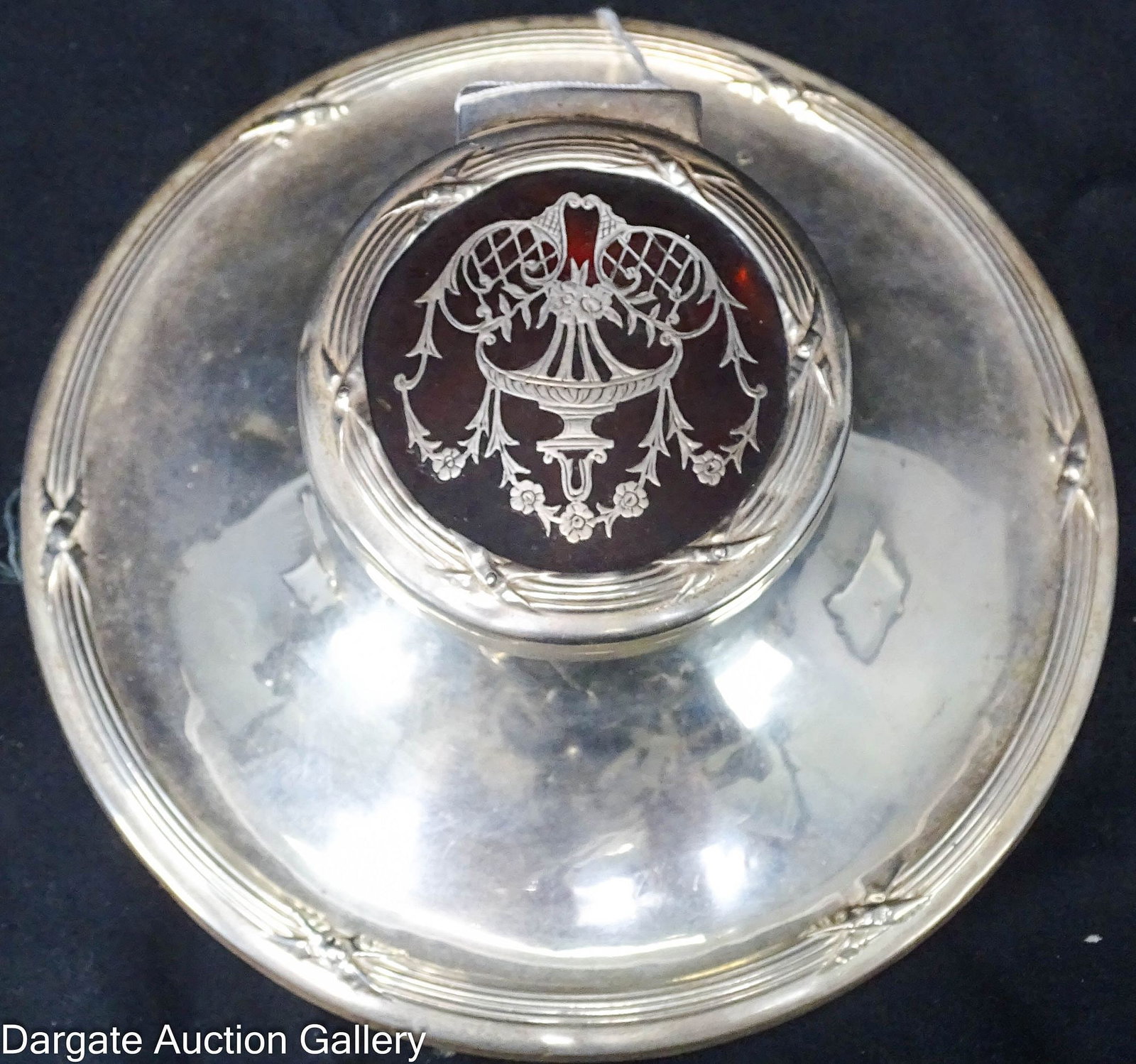 WEIGHTED ENGLISH STERLING INKWELL WITH SHELL LID: Weighted English sterling inkwell with shell lid hallmarked [Birmingham, Sterling,1902] by Henry Matthews. Capstan sterling inkwell with faux tortoiseshell insert featuring sterling inlay of a cl