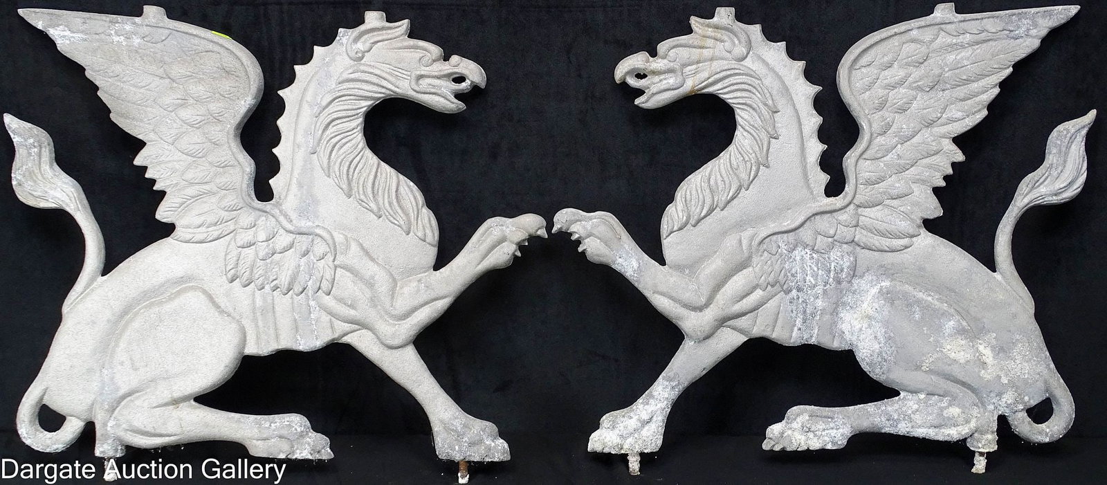 PAIR CAST ALUMINUM GRIFFIN SCULPTURES: pair of flat 2-sided griffins; these have metal studs on the bottom and were mounted on a wall or in a garden; Measures: 19"H x 21"W x 1.5"D, 14.75" (distance between studs - cente
