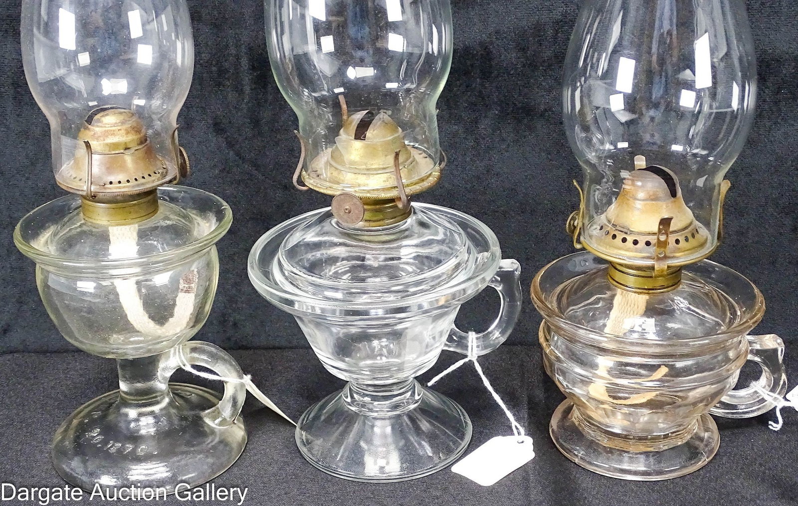 (3) 1870 LOMAX & ADAMS HAND LAMPS: (3) Colorless hand lamps, including: Lomax globe hand lamp embossed [PAT SEPT 20 1870] on base, #1 burner [D & A CO PAT 1-16-83 and 8-17-97]; 5.75"H to top of collar, 3.75"