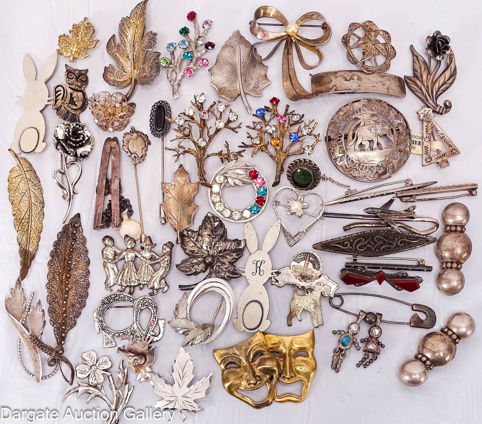 45 ASSORTED PINS AND BROOCHES inclds STERLING: Includes: theater mask pin - gold wash [STERLING] (11) leaf pins in different styles, all marked Sterling (4) floral pins - filigree pin is not marked, the remainder are marked Sterling (4)